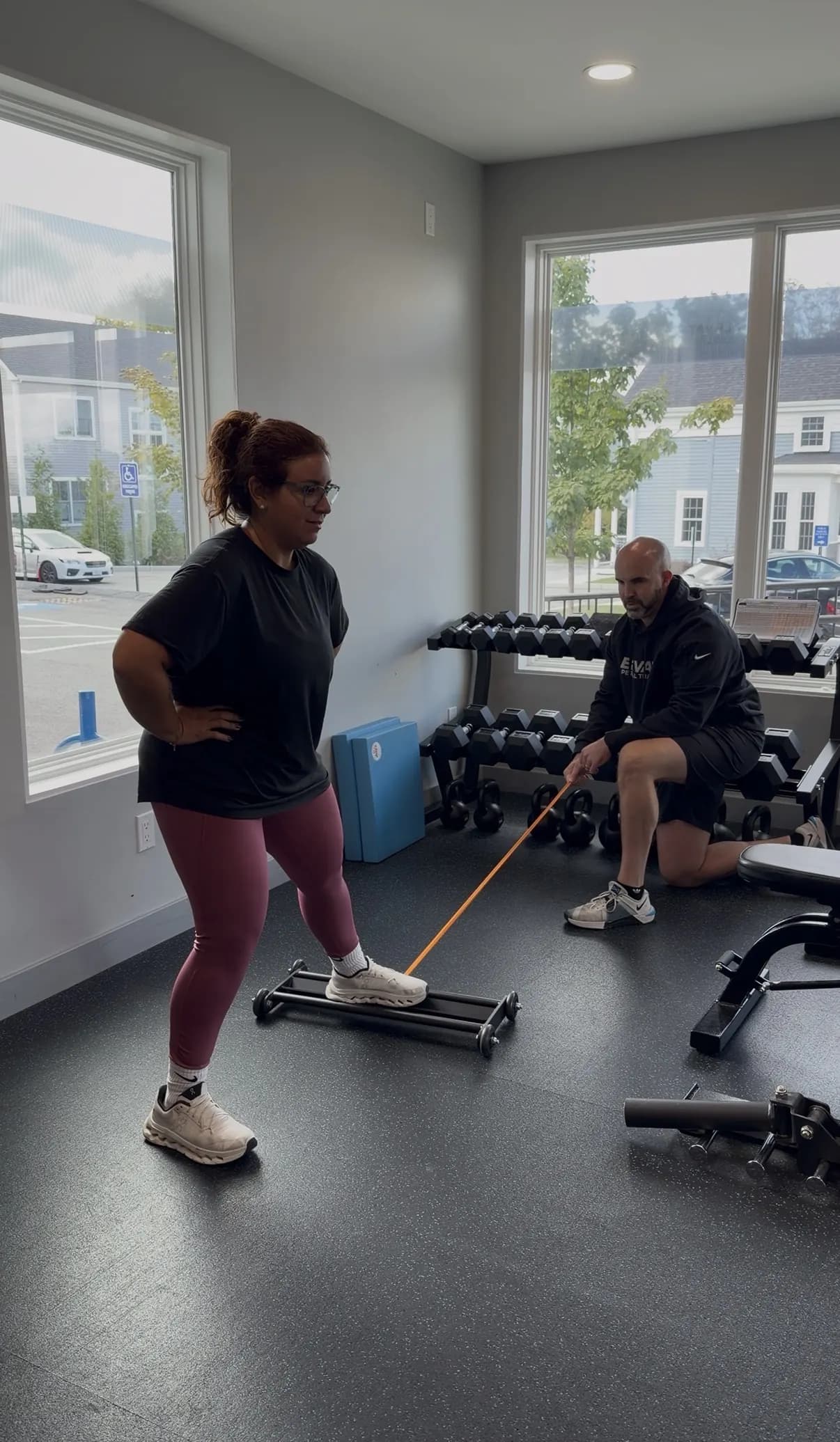 Trainer coaching a client through a sled push