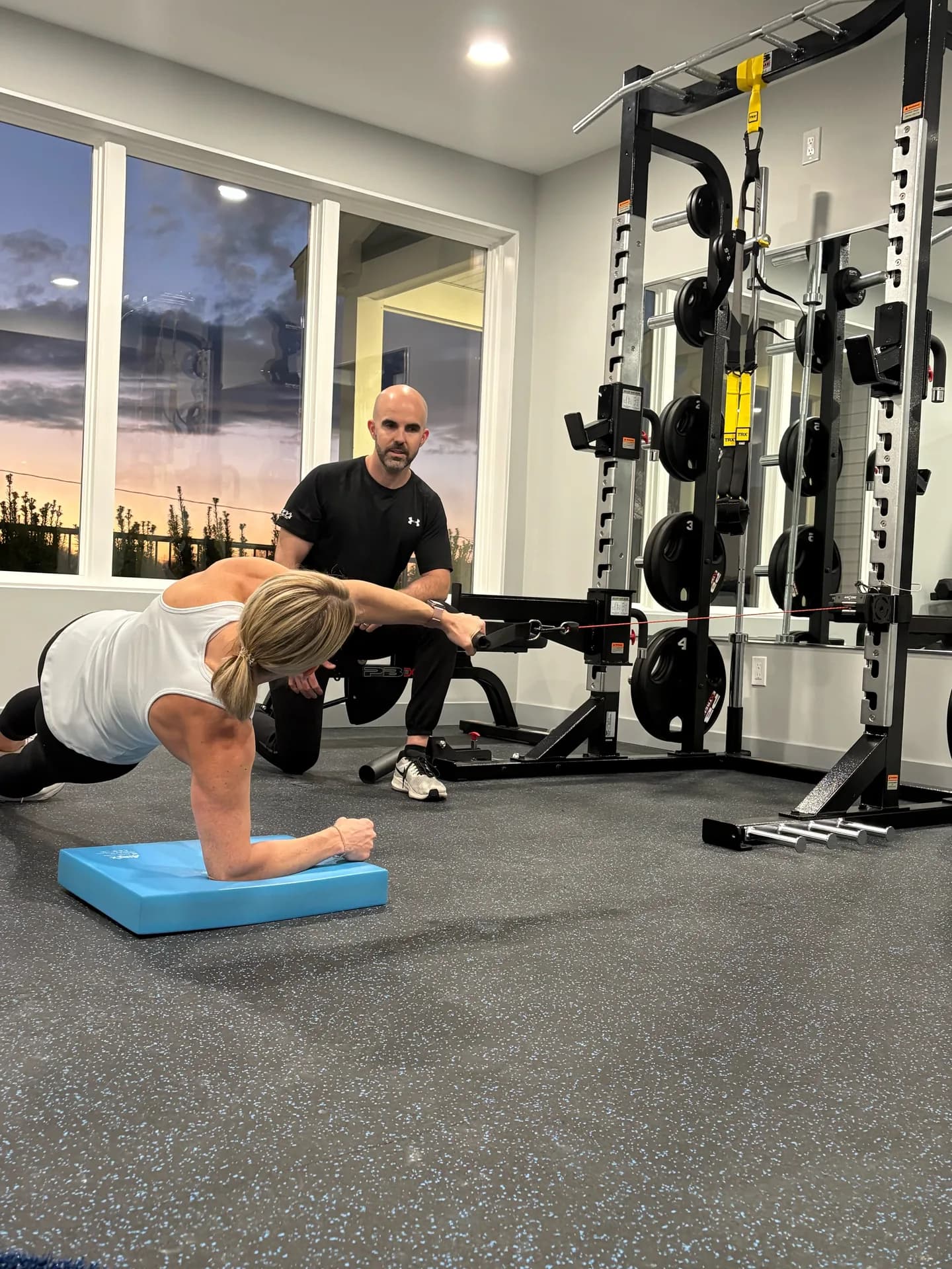 A client training with a cable machine in the Elevate studio
